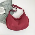 Minimalist large burgundy crescent tote bag with adjustable strap and puffy texture - Red