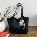 Vintage black leather tote bag with a cute teddy bear pendant for women's daily fashion - Black