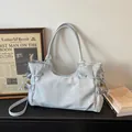 Sac fourre-tout minimaliste en cuir gris clair avec cordons latéraux et intérieur spacieux - Bleu