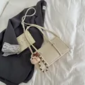 Retro cream white oil wax leather baguette bag with a cute bear charm on gray blazer - Cream White with Pendant
