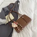 Brown oil wax baguette bag with lychee texture, metal accents and cute bear charm - Brown with Pendant