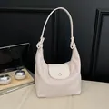 Minimalist beige dumpling shoulder bag with matte texture and adjustable strap - Off White