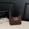 Minimalist dark brown suede dumpling bag with leather strap and metal button closure - Brown