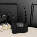 Retro black nylon dumpling shoulder bag with PU leather flap and silver buckle details - Black