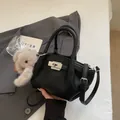 Black litchi grain leather tote bag with silver rotary lock and plush puppy charm - Black With Pendant