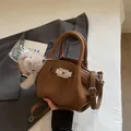 Brown litchi grain pleated handbag with silver buckle and plush bunny charm accessory - Brown with Pendant