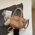 Beige lychee leather shoulder bag with pleated detail and cute plush rabbit charm - Khaki With Pendant