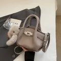 Elephant grey lychee leather handbag with adjustable strap and cute rabbit pendant - Grey With Pendant