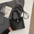 Minimalist black lychee texture bucket bag with silver buckle and crossbody strap - Without Pendant / Black