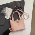Chic pink bucket bag with litchi texture and adjustable strap on a minimalist background - Without Pendant / Pink