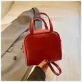 Minimalist red leather square handbag with top handle and adjustable shoulder strap - Red