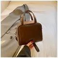 Minimalist dark brown square handbag with smooth faux leather finish and top handles - Brown