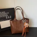 Deep brown leather tote bag with large capacity and cute plush charm on handle - With Pendant / Brown