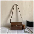 Dark brown faux leather crossbody bag with buckle detail and plush pony charm - Brown with Pendant