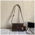 Dark brown retro tote bag with buckle detail and plush horse charm in soft lighting - Coffee With Pendant