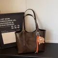 Deep brown retro tote bag with PU leather texture and plush charm accessory - With Pendant / Coffee