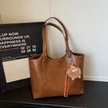 Sac cabas marron en cuir vintage avec longues bandoulières et pendentif monstre en peluche - Avec Pendentif / Brun Jaune