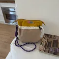 Bolso bandolera de lona en contraste amarillo y beige con correa trenzada - Caqui