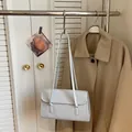 Minimalist light blue rectangular shoulder bag with dual straps and matte leather finish - Blue