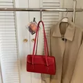 Minimalist red leather shoulder bag in a rectangular shape with sleek glossy finish - Burgundy