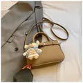 Dark khaki lychee leather handbag with adjustable strap and cute teddy bear charm - Grey With Pendant
