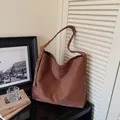 Large dark brown suede tote bag featuring a minimalist design and adjustable shoulder strap - Brown