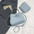 Light blue pebbled leather bucket bag with matching mini pouch and shoulder strap - Main Bag and Pouch / Blue
