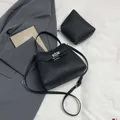 Chic black litchi grain leather bucket bag with metal twist lock and matching pouch - Main Bag and Pouch / Black