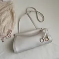 Chic cream white crossbody bag with lychee texture leather and gold ring hardware detail - White