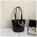 Glossy black bucket shoulder bag with cherry and pearl pendant detail - Black With Pendant