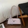 Detail of light pink polka dot underarm bag with leather bow and silver heart pendant - Pink Without Pendant