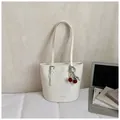 White minimalist PU leather bucket shoulder bag with cherry pendant and FASHION & BAGS logo - White With Pendant