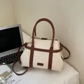 Cream canvas tote bag with brown leather trim and adjustable crossbody strap for daily commute - Off White