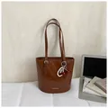Brown glossy patent leather tote bag with cherry charm and fashion branding - Brown with Pendant