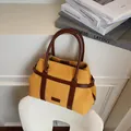 Fashionable ginger yellow canvas tote bag with brown leather handles for daily commute - Yellow