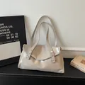 Chic cream-white patent leather tote bag with elegant glossy finish and minimalist design - Khaki
