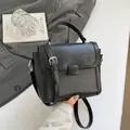 Minimalist black baguette shoulder bag with brushed texture and silver hardware - Black