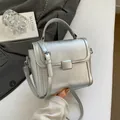 Elegant silver textured small handbag with top handle and shoulder strap - Silver
