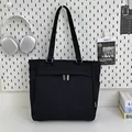 Minimalist black canvas tote bag with dual zipper detail and side pocket for daily use - Black