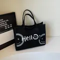 Sac fourre-tout minimaliste en toile noire avec texte Hello et imprimé smiley blanc - Noir