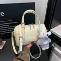Beige cylindrical pillow bag in glossy synthetic leather with a cute plush bear charm - With Pendant / Yellow