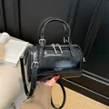 Glossy black leather Boston cylinder bag with silver hardware and adjustable shoulder strap - No Pendant / Black