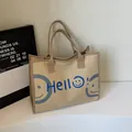 Sac cabas minimaliste en toile beige avec texte Hello bleu et motif smiley - Kaki