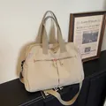Large beige travel duffel bag with shoulder strap and multiple zip compartments - Off White