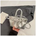 Chic silver metallic bucket bag with decorative buckle and detachable strap - Silver