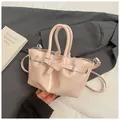 Modern light pink bucket bag with silver metal buckle and tubular top handles - Pink