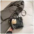 Minimalist black plaid shoulder bag with leather trim and plush charm pendant - With Charm / Black
