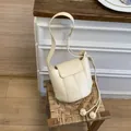 Chic cream white bucket bag with flap closure and elegant knot tassel detail - White Without Pendant