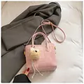 Pink textured bucket bag with leather trim and plush bear charm on white fabric - With Charm / Pink