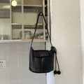Classic black leather bucket bag with decorative knots and flap closure for casual style - Black without Pendant